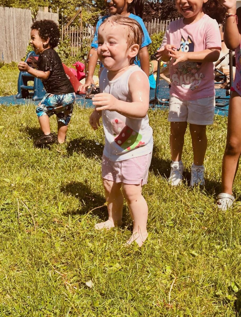 Little one playing in the sprinkler
