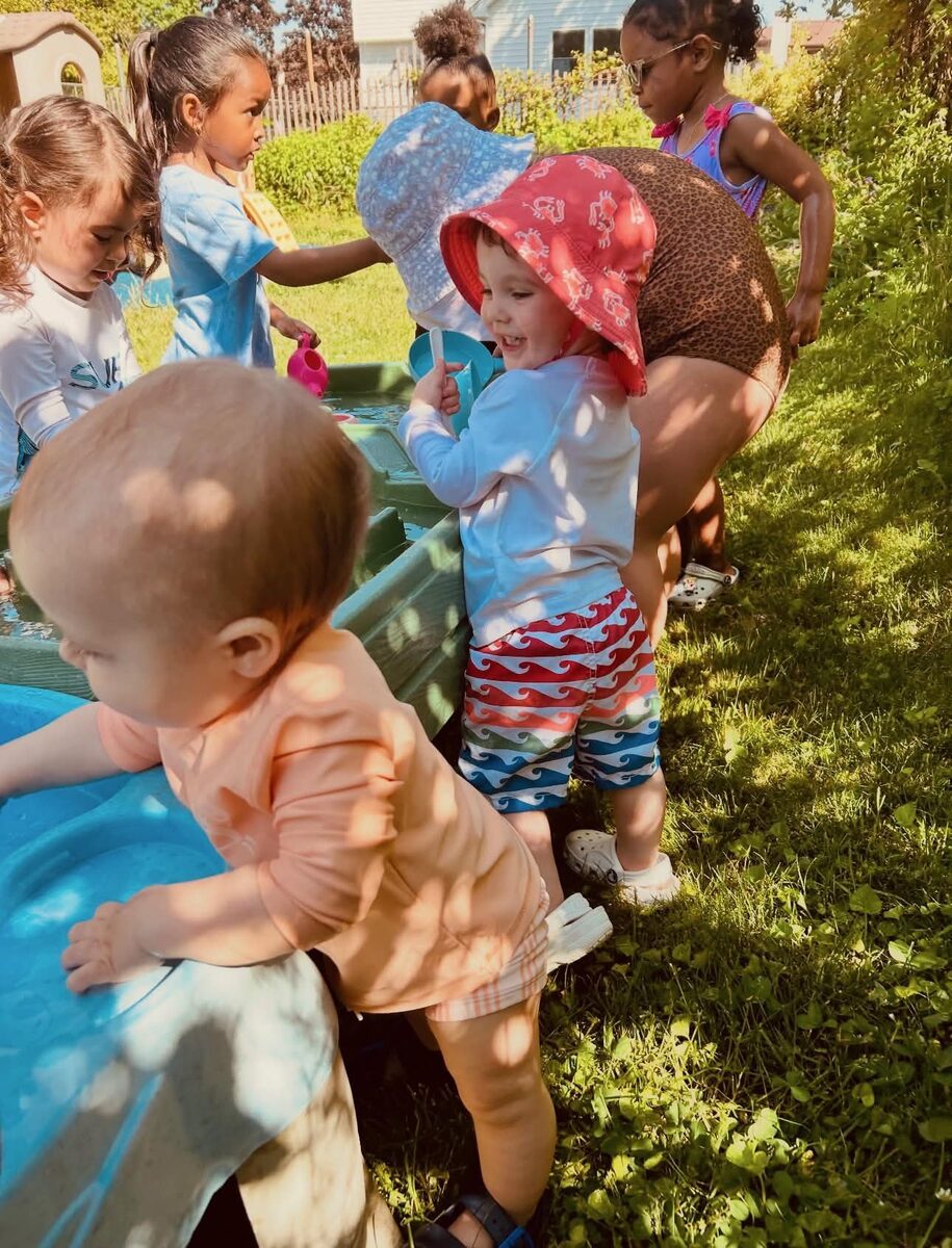 Kids gathered around the water table